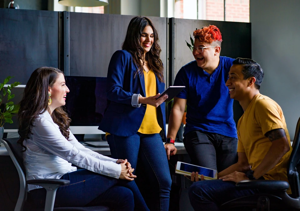 Colleagues collaborating around an office table.